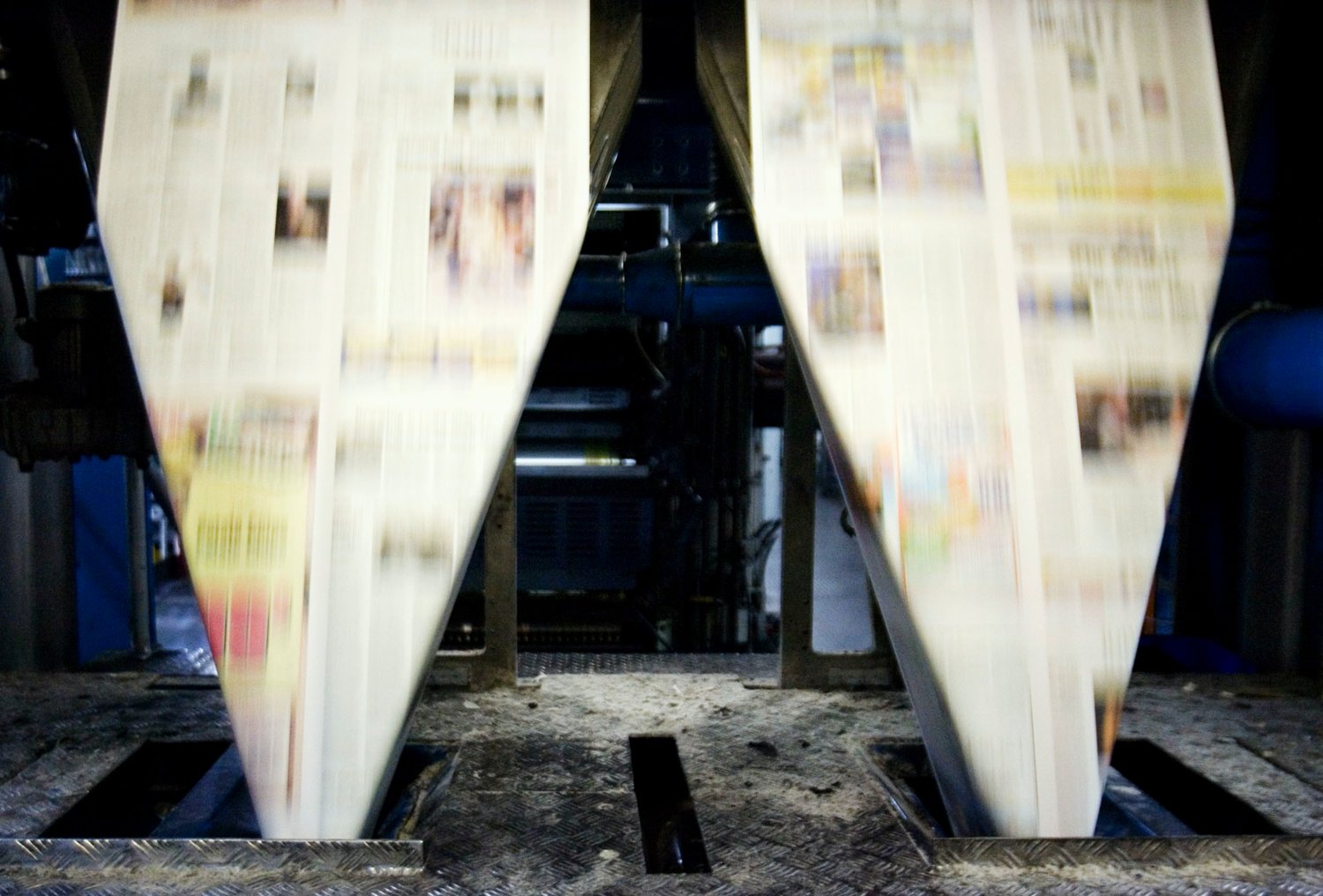 Newspapers enter the folder after being printed at the Colorweb press. (Photo by Liz Martin/The Gazette)